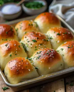 Freshly baked garlic bread rolls with herbs and melted butter