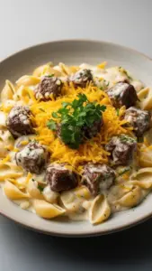 Cajun steak bites served with cheesy garlic pasta on a plate