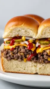 Delicious cheeseburger sliders served on a platter with toppings