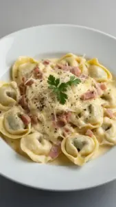 Delicious creamy tortellini carbonara served in a bowl.