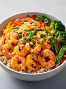 Honey garlic shrimp bowls with fresh vegetables and rice on a plate