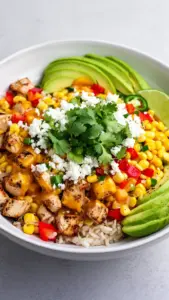 Delicious Street Corn Chicken Rice Bowl with chicken, corn, and rice.